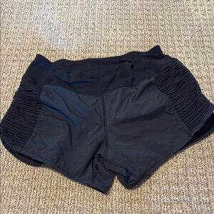 Women’s Lululemon black athletic shorts low rise 2” inseam size 4